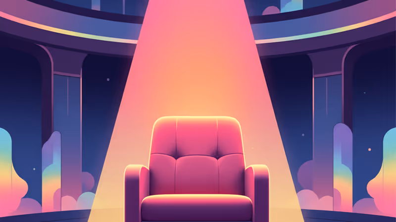 A spotlight on an empty red theater seat