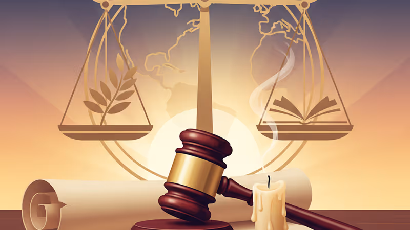 A gavel and an extinguished candle in a courtroom.