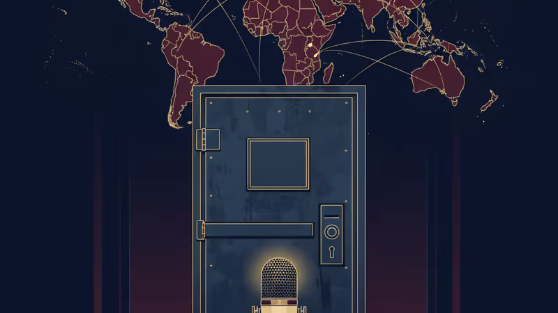 A TV microphone positioned in front of a locked steel door in a dark hallway.