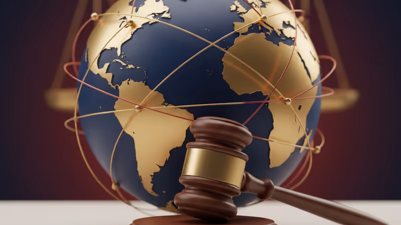 A wooden gavel and scales of justice in a courtroom