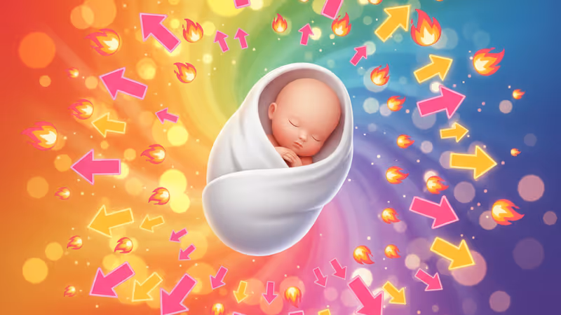 A sleeping newborn wrapped in a white blanket with golden New Year lights