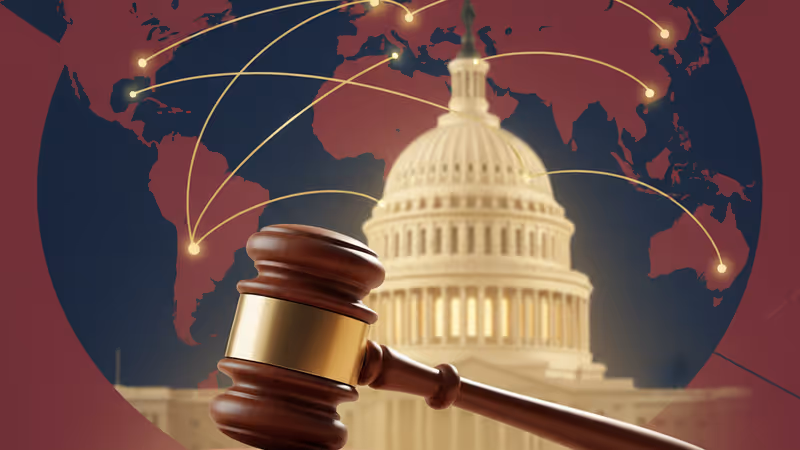 A legal gavel on a desk with the US Capitol in the background.